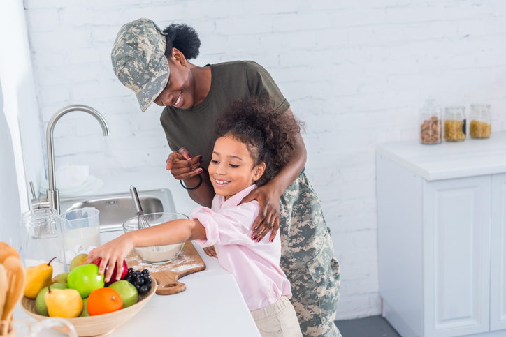 child and military mother in the kitchen